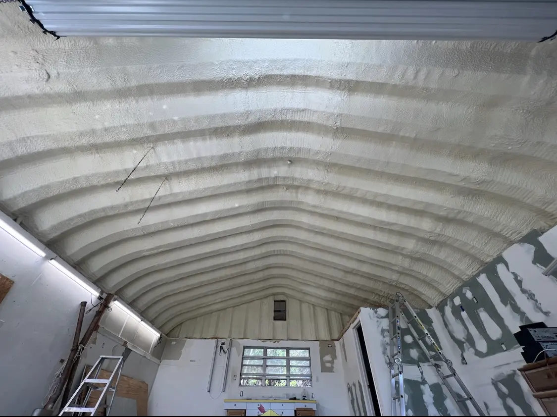Spray polyurethane foam applied to the underside of a metal roof deck in Cicero